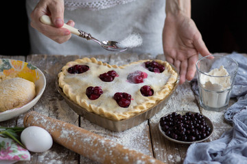 Obraz na płótnie Canvas Cooking cherry pie. Work with the test.Bake a fruit cake in the shape of a heart. Delicious homemade cake do it yourself. Cooking. Valentine's Day. Heart shape. Ready for Valentine's Day.