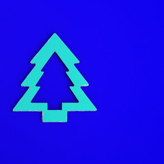 Fototapeta premium Merry Christmas and Happy New Year greeting card with geometric holiday tree on blue paper background with copy space.