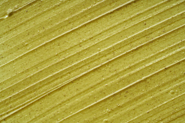 Texture and strokes of a light green organic mask for face or body cream isolated on white...