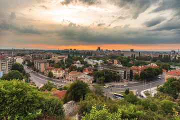 Fototapeta na wymiar Summer sunset. Photo from Nebet tepe Hill in Plovdiv city, Bulgaria. Panoramic view with warm sunset. Ancient Plovdiv is UNESCO's World Heritage.