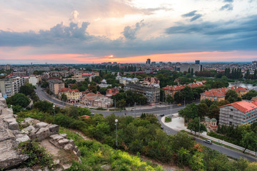 Fototapeta na wymiar Summer sunset. Photo from Nebet tepe Hill in Plovdiv city, Bulgaria. Panoramic view with warm sunset. Ancient Plovdiv is UNESCO's World Heritage.