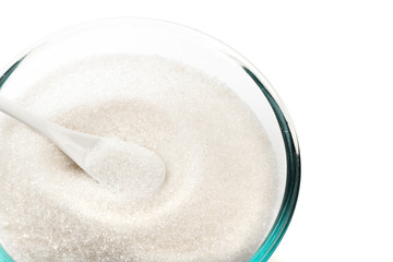 Sugar in glass bowl isolated on white background