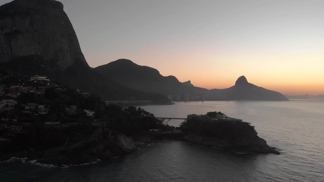 Aerial view of Joatinga beach with the Gavea, Vidigal and Corcovado mountains of Rio de Janeiro in the background and Costa Brava club on an island in the foreground at golden hour