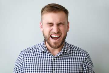 Obraz premium Stressed young man on light background