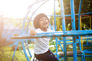 Healthy little kids are playing in the backyard, happy with the swings, rocking horses, slide carriages.