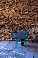 woodpile in  woodshed  is  wheelbarrow