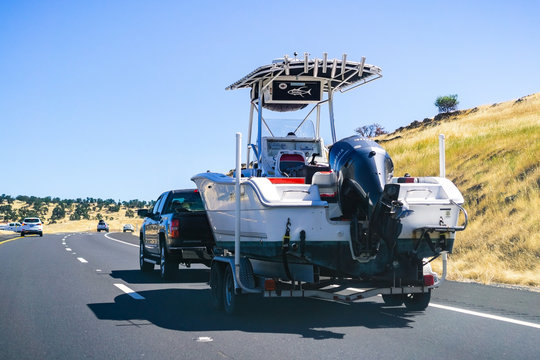 June 26, 2019 Oakdale / CA / USA - Truck towing a  boat on the freeway
