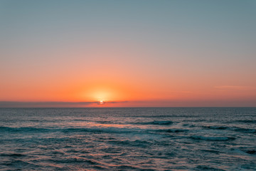 Sunset on sea or ocean. Wavy surface. Horizon line. Relaxation, vacation concept