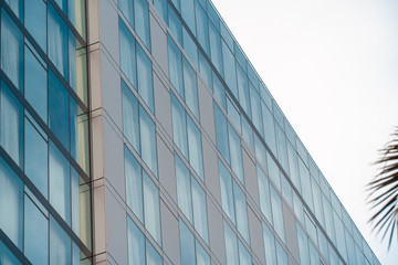 Fototapeta na wymiar Real estate lease concept. Blue windows of office building close up