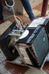 a professional electrician is cleaning the window air conditioner