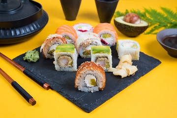 A set of sushi roll different kinds of yellow . Traditional Asian food.