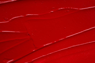 Smear and texture of red lipstick or acrylic paint isolated on white background.