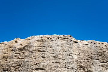 Old rock on a blue sky background