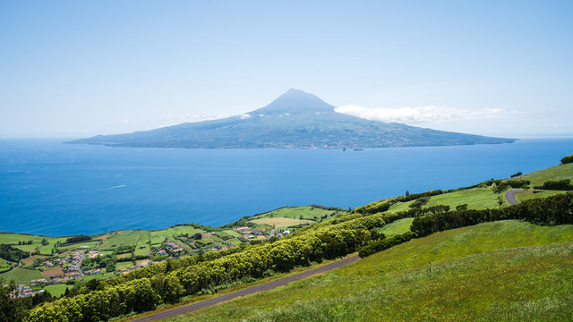 The volcanic island of Pico with the famous Pico volcano and the atlantic ocean, coastline of Faial Island, Azores Islands, Portugal