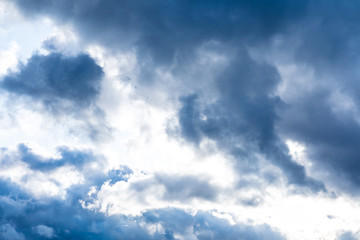 The vivid sky or heaven background with white and blue clouds under the sun rays