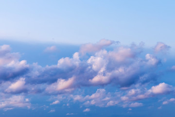 The vivid sky or heaven background with white and blue clouds under the sun rays
