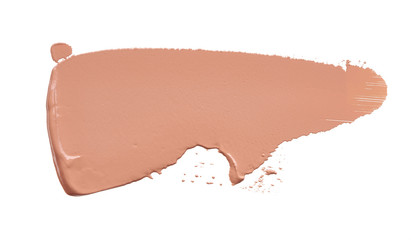 Gently beige strokes and texture of makeup foundation or acrylic paint isolated on white background