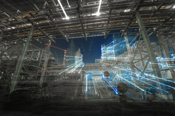 worms-eye view of metal pipes of illuminated industrial plant outdoor at night 