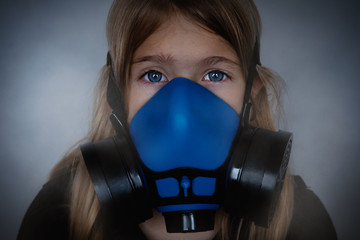 Young girl wearing gasmask, respirator portrait. Effects of worldwide air pollution, industrial influence on environment. Protection from dangerous air particles, gas, smog, transmitted diseases
