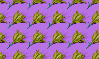 Seamless pattern of golden lilies on purple background trend flat lay concept with fashionable toning. Many flowers pattern