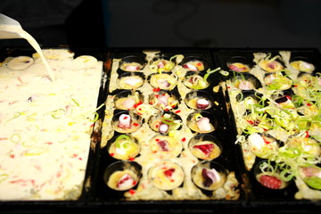 Tokyo,Japan-August 16, 2019: Takoyaki or octopus balls or octopus dumplings on cast iron