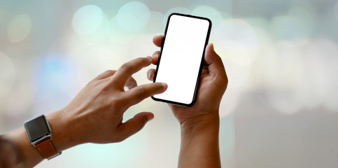 Close-up view of man holding blank screen smartphone