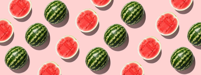 Colorful fruit background of fresh half watermelon on pink background - obrazy, fototapety, plakaty