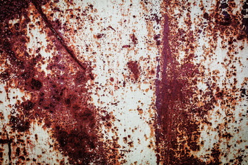 Old metal rusted wall partly covered with peeling paint. Grunge texture and background. Close-up