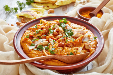 hearty spicy Mulligatawny soup in a clay bowl