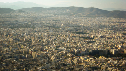 Beautiful views from the height of a bird's flight to homes in Athens (Greece), with beautiful mountains in the background.