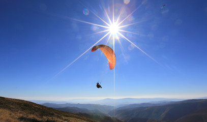 paraglider fly in mountains