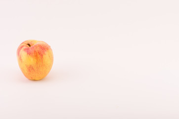 yellow red apple fruit on a white surface - natural nutrition