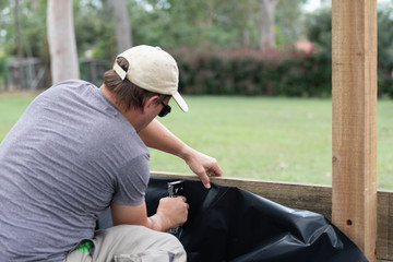 Handy man using staple gun