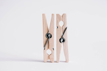 Set of two wooden cloth pegs isolated on white background