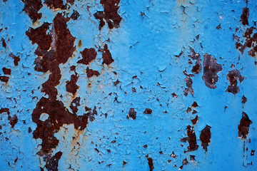 Old metal rusted wall partly covered with peeling paint. Grunge texture and background. Close-up