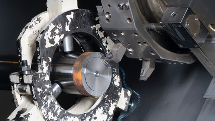 The CNC lathe machine chucking the metal shaft.The turning machine cutting forming cutting the metal shaft