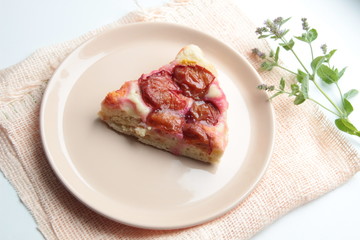 Slice of plum cake on plate with background