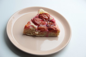 Slice of plum cake on plate with background