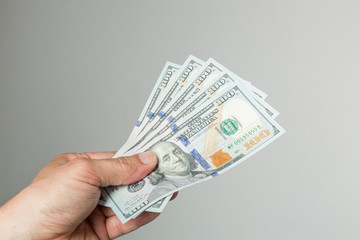 hand with hundred dollar bills