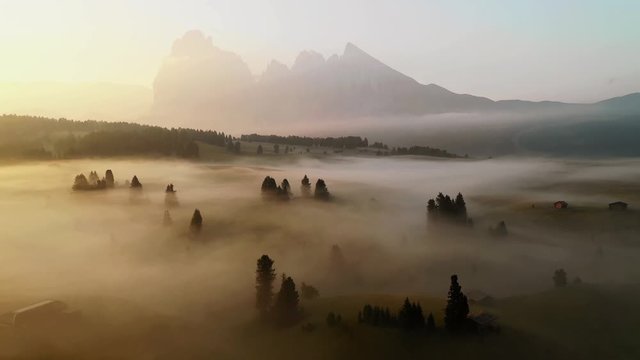 Sunrise drone aerial video in the Dolomites mountains. It was taken at Seiser Alm plateau on an amazing mystic morning with perfect foggy conditions.