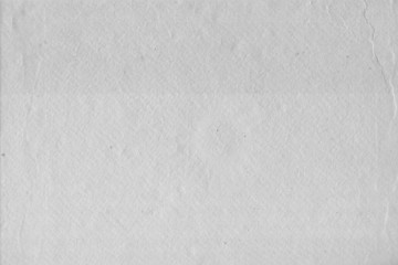 Cardboard white texture close-up. Light old paper background. Grunge concrete wall. Vintage blank wallpaper.