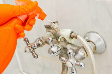 Housemaid cleaning a bathroom, closeup shot