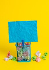 Fototapeta premium Trash bin crumpled paper clothespin empty reminder office supplies yellow