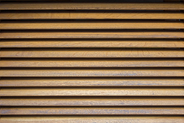 yellow gray wooden shutters with shadows. horizontal lines. rough surface texture