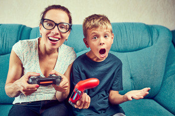 Young mom and son play video games
