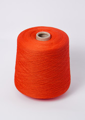 Green bobbin of yarn on a white background.Textile reel on isolated white background.