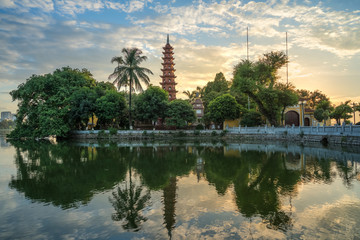 Fototapeta na wymiar Hanoi cityscape at twilight. Tran Quoc pagoda, the oldest temple in Hanoi, Vietnam
