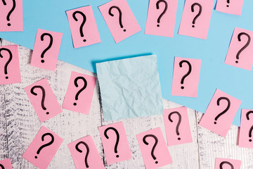 Scribbled and crumbling papers with thick cardboard above wooden table.