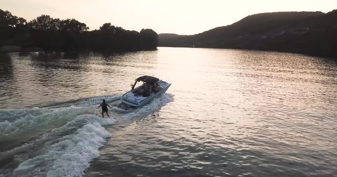 Aerial drone shot of a boat with a wakeboarder on the Colorado River.
