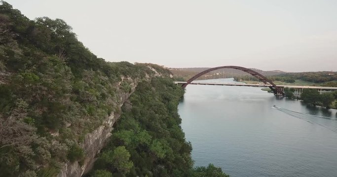 Aerial Drone Shot of the hills in Austin, TX, with the 360 bridge in the background.